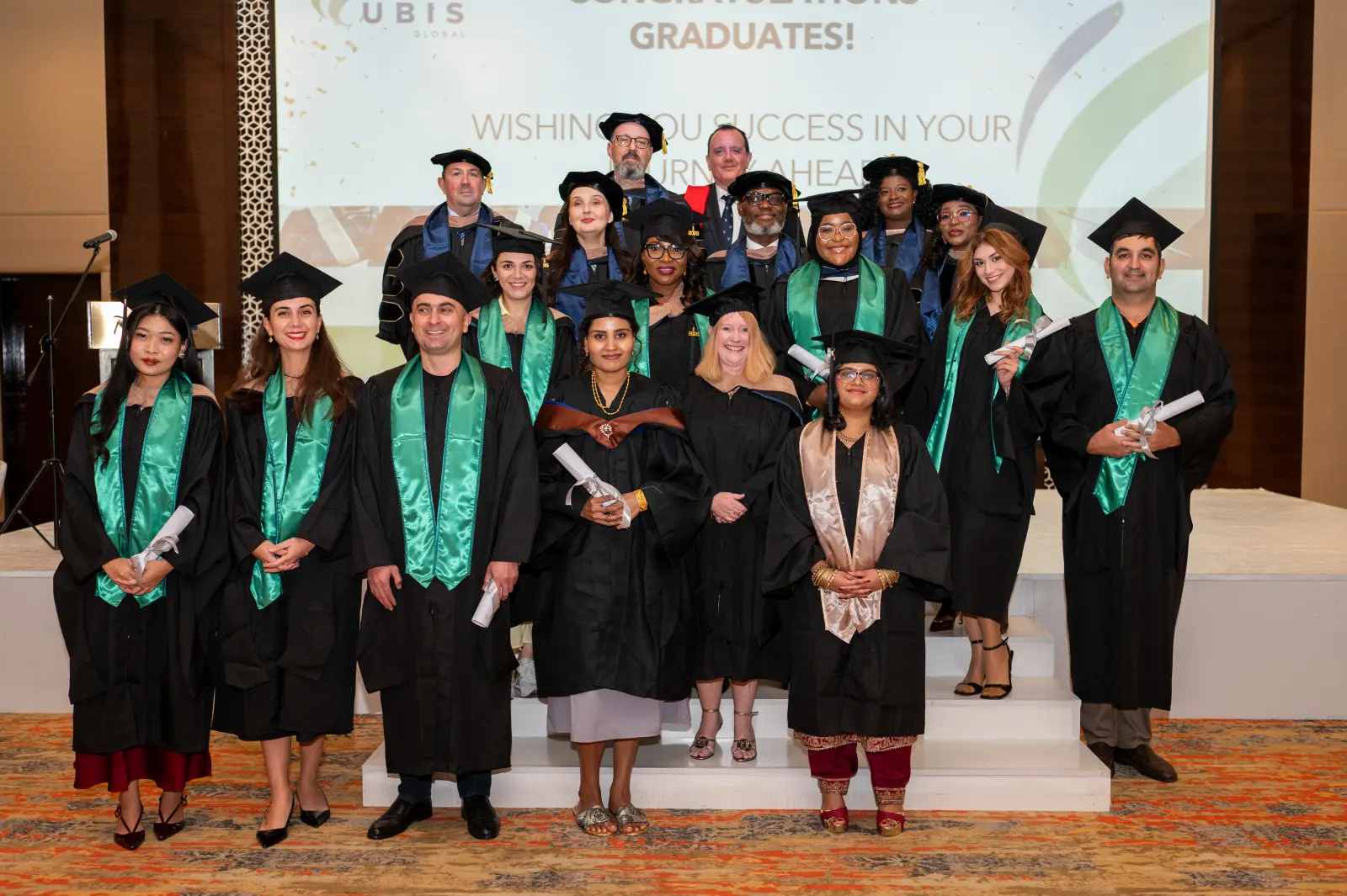 UBIS graduates throwing their caps at graduation